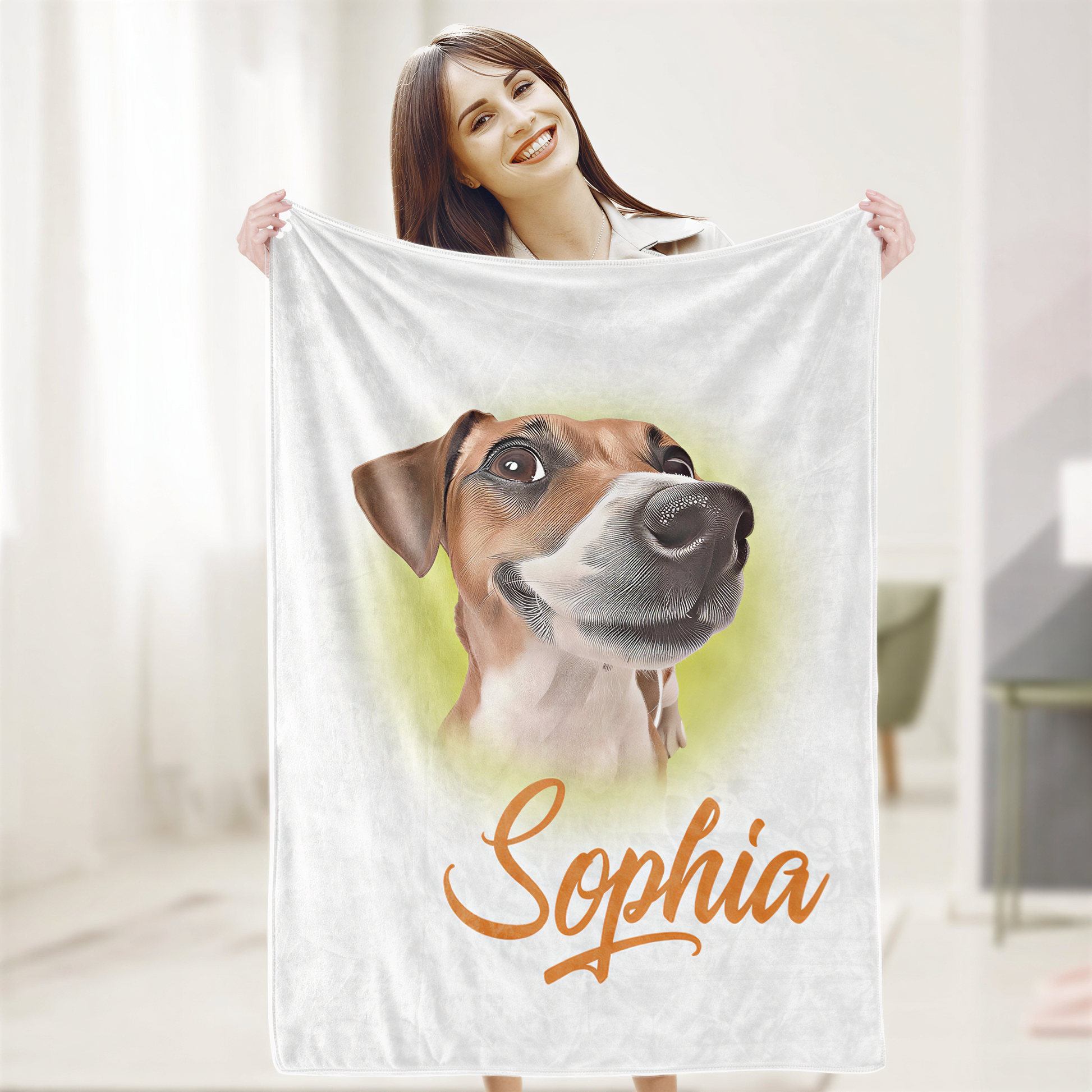A woman is holding up a white towel with a printed image of a dog's face and the name "Sophia" written on it.