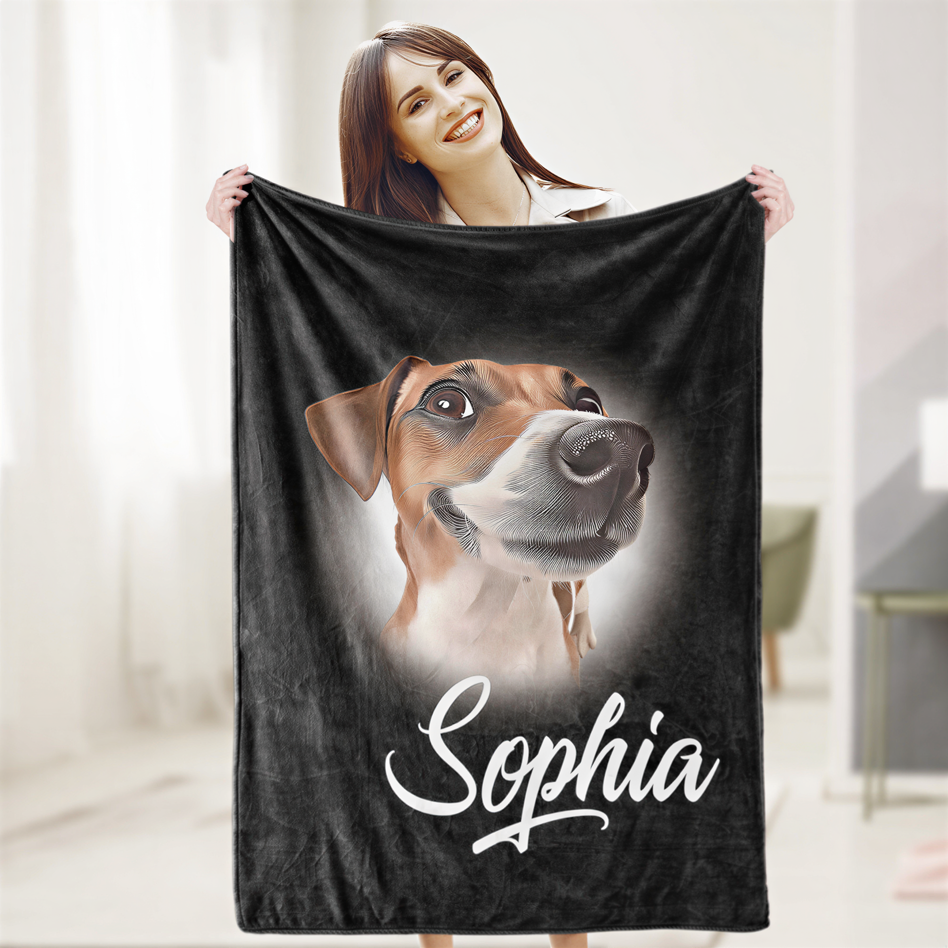 A woman is holding up a black blanket with a picture of a dog on it, and the name "Sophia" is written below the image.