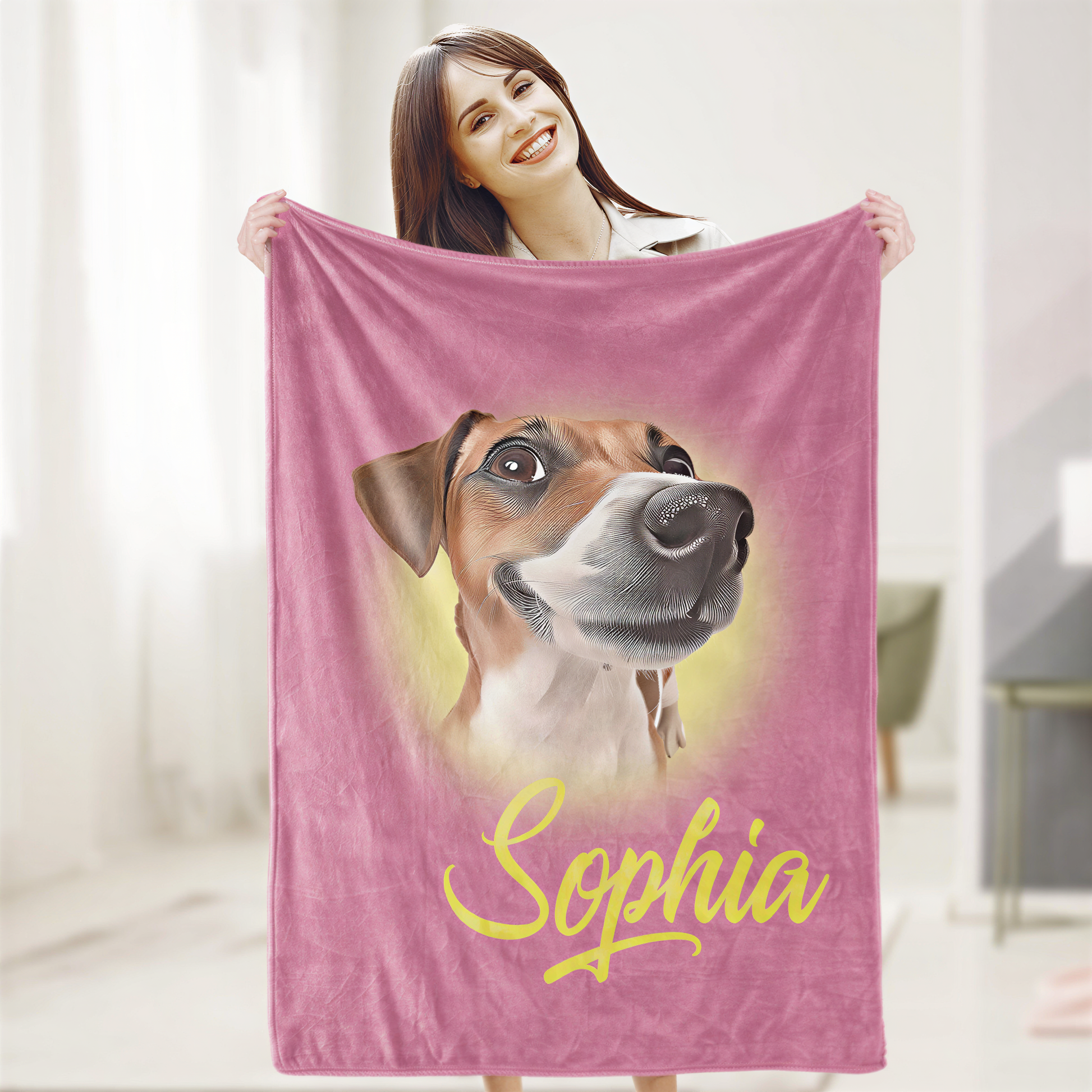 A woman is holding up a pink blanket with a dog's face printed on it, and the name "Sophia" written below the image.