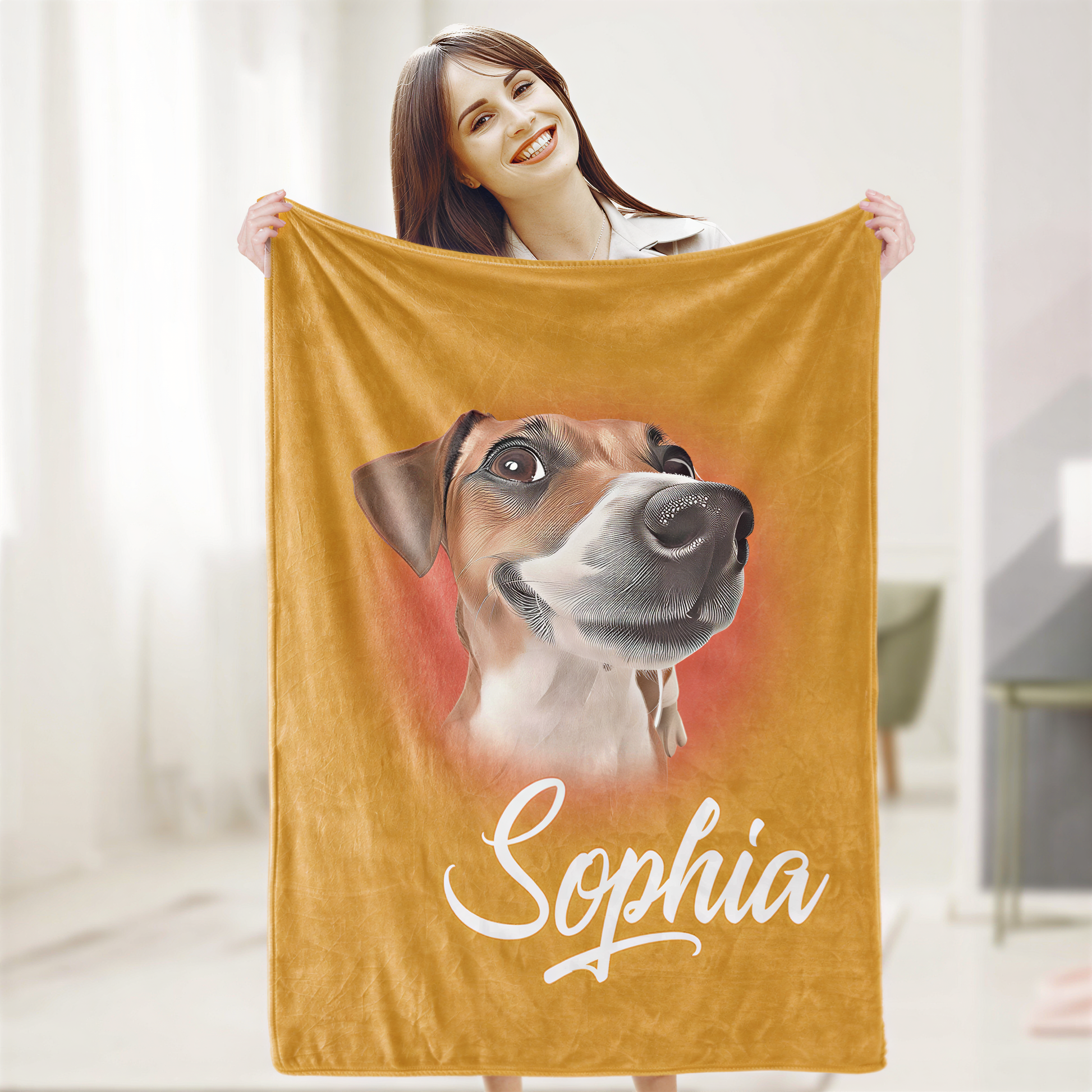 A woman is holding up a yellow blanket with a picture of a dog on it, and the name "Sophia" written below the image.