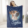 A woman is holding a blue blanket with a picture of a dog on it, and the name 