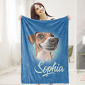 A woman is holding a blue blanket with a picture of a dog on it, and the name 