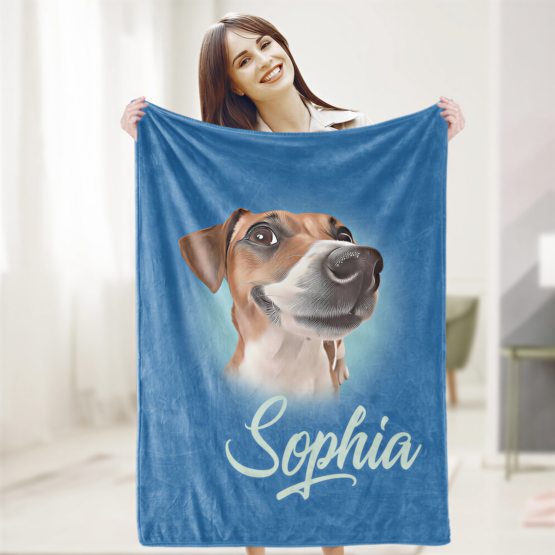 A woman is holding a blue blanket with a picture of a dog on it, and the name "Sophia" is written below the image.