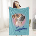 A woman is holding a blue blanket with a dog's face printed on it, and the name 